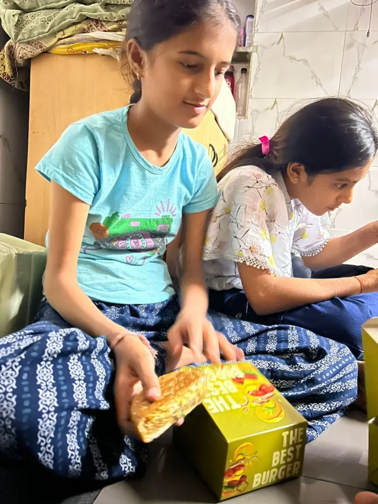 Girls opening burger boxes at the Bacha Party, Ahmedabad